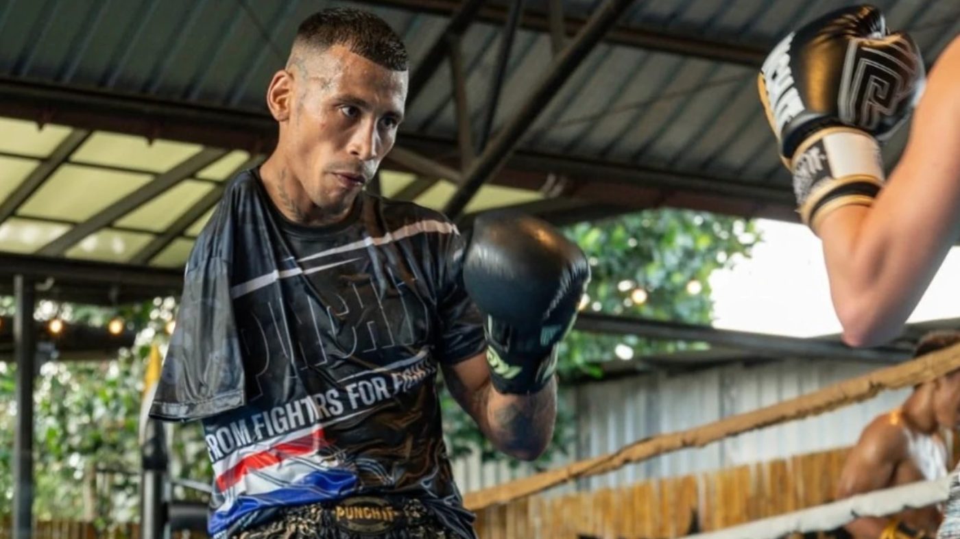 Carlitos Machado on the pads in an open air gym